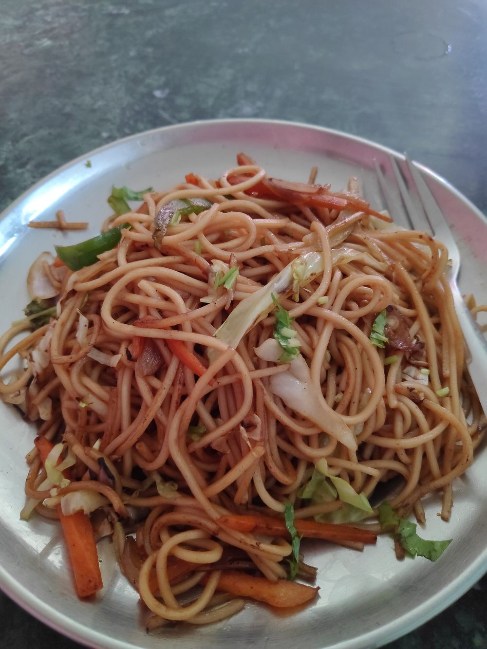 Plate of vegetable chowmein noodles with cabbage and carrot